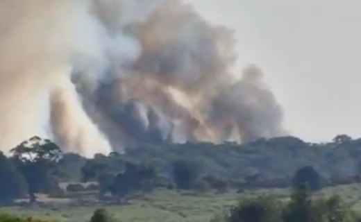 Huge wildfire breaks out next to major A-road after van bursts into flames