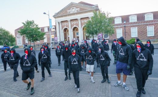 More than 50 masked protesters gathered in Clacton just minutes before Nigel Farage declared by-election winner