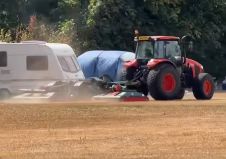 Furious farmer uses tractor to help clear off travellers after caravans pitch up outside primary school